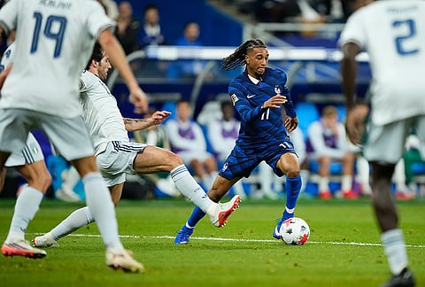 France's Michael Olise, right, and Italy's Sandro Tonali challenge for the ball during the UEFA Nations League Group A soccer match between France and Italy in Saint-Denis near Paris, Friday, Oct. 2, 2026. 