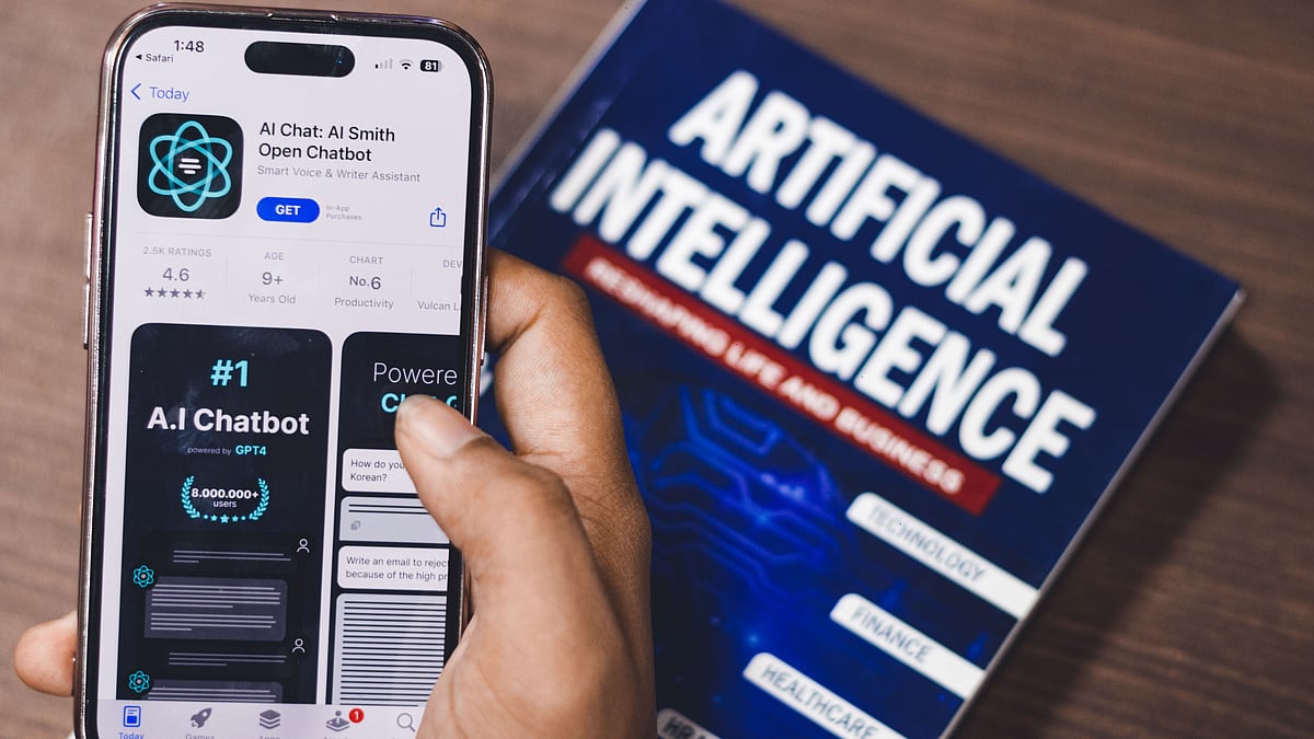 A smartphone displaying AI app with a book on AI technology in the background - Pexels/ Sanket Mishra