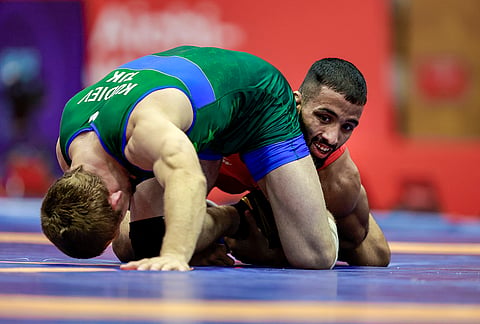 India's Sujeet Kalkal competes in the men's Freestyle 65 kilogram final bout 196 wrestling match against Tajikistan's Abdulmazhid Kudiev, front, in the ongoing Asian Games 2026, in Nagoya, Japan, Friday, Oct. 2, 2026.