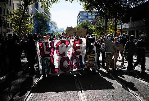 Students hold a banner reading : "High school blockaded" during a protest against under-resourced schools in Lyon, France, Friday, Oct. 2, 2026. 