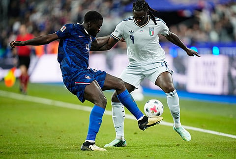 Italy's Moise Kean, right, and France's Dayot Upamecano challenge for the ball during the UEFA Nations League Group A soccer match between France and Italy in Saint-Denis near Paris, Friday, Oct. 2, 2026. 