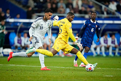 Italy's Gianluca Scamacca, left, and France's goalkeeper Mike Maignan challenge for the ball during the UEFA Nations League Group A soccer match between France and Italy in Saint-Denis near Paris, Friday, Oct. 2, 2026.
