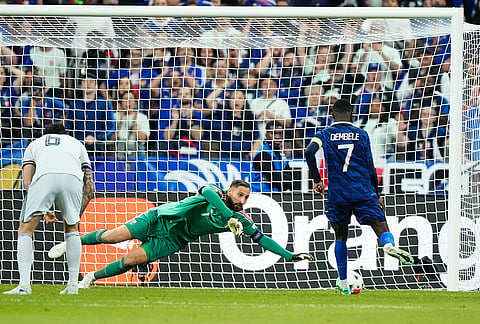 Italy's goalkeeper Gianluigi Donnarumma makes a save of a shoot by France's Ousmane Dembele, right, during the UEFA Nations League Group A soccer match between France and Italy in Saint-Denis near Paris, Friday, Oct. 2, 2026. 

