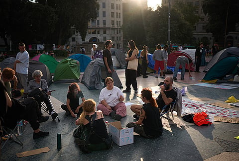 Demonstrators sit next to their tents after spending the night camping during a protest demanding stronger protections for renters following last week's eviction of 87-year-old Maricarmen, in Barcelona's Plaça de Catalunya, Spain, Wednesday, Sept. 30, 2026. 
