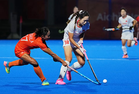 China's Zou Meirong, right, competes for the ball with India's Sushila Pukhrambam during the women's hockey gold medal match at the Asian Games in Gifu, Japan, Friday, Oct. 2, 2026.