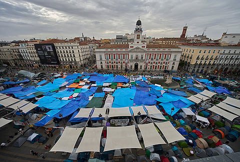 Activists camp during a protest following the eviction last Wednesday of 87-year-old Maricarmen to demand stronger laws to protect renters at Sol square in Madrid, Spain, Wednesday, Sept. 30, 2026. 