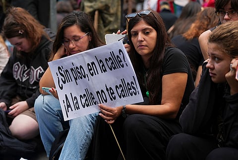 Activists holding a banner reading in Spanish: "No flat, left on the street? Take to the streets, don't stay silent!" gather near the Spanish Parliament following the eviction of 87-year-old Maria del Carmen Abascal to demand stronger laws to protect renters in Madrid, Spain, Friday, Oct. 2, 2026. 

