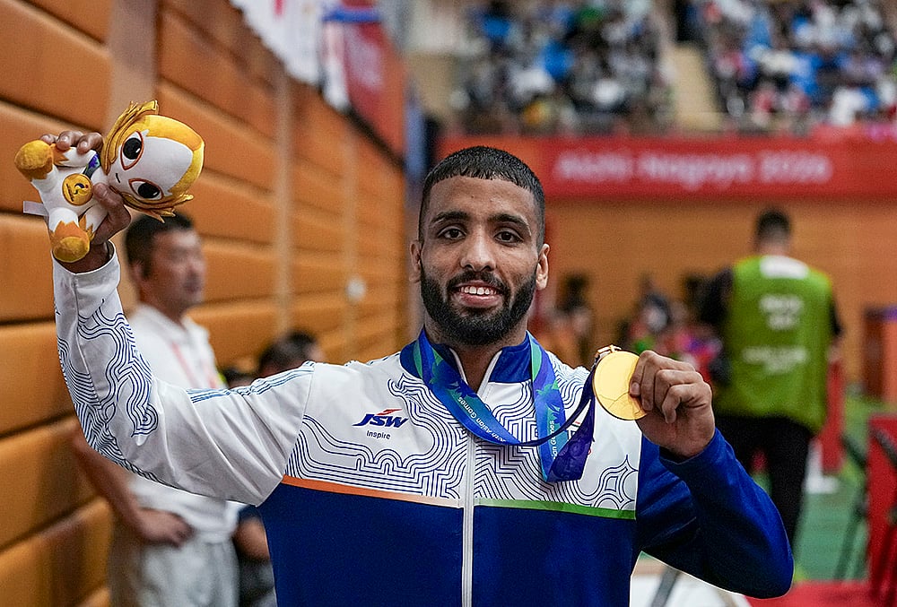 India's Sujeet Kalkal poses for photographs after winning gold medal in the men's Freestyle 65 kilogram final bout 196 wrestling event in the ongoing Asian Games 2026, in Nagoya, Japan, Friday, Oct. 2, 2026. 
 - | Photo: PTI/Arun Sharma