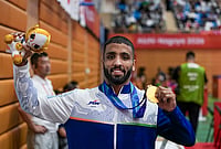 | Photo: PTI/Arun Sharma : India's Sujeet Kalkal poses for photographs after winning gold medal in the men's Freestyle 65 kilogram final bout 196 wrestling event in the ongoing Asian Games 2026, in Nagoya, Japan, Friday, Oct. 2, 2026. 

