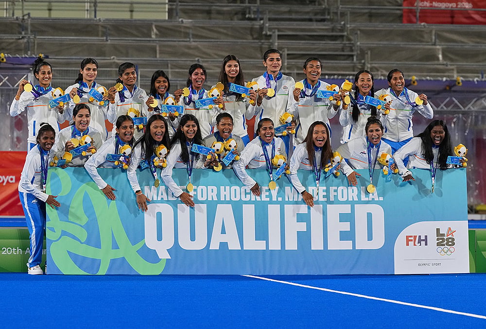Gold medalists India celebrate on the podium holding a board stating their qualification to LA olympics, during the medal ceremony after the women's hockey finals at the Asian Games in Gifu, Japan, Friday, Oct. 2, 2026. 
 - | Photo: AP/Mark Baker
