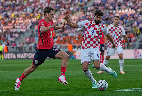 Croatia's Josko Gvardiol clears the ball in front of England's Alex Scottduring the Nations League soccer match between Croatia and England in Rijeka, Croatia, Saturday, Oct. 3, 2026. 
