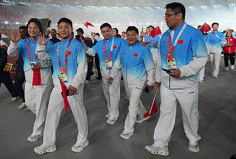Chinese athletes react during the closing ceremony for the Asian Games in Nagoya, Japan, Sunday, Oct. 4, 2026. 
