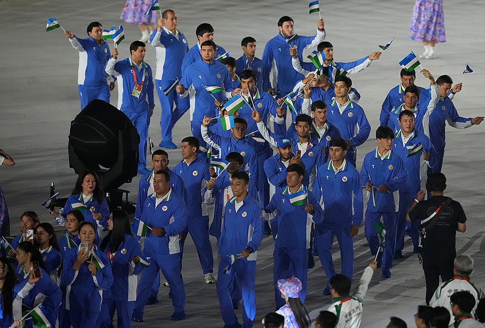 Athletes from Uzbekistan march into the arena during the closing ceremony
