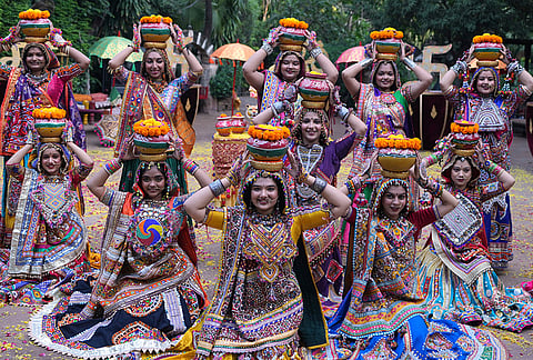 Artists wearing traditional attire pose for photograph before practice the Garba, a traditional dance of Gujarat state, during a rehearsal of Navratri, or the nine night Hindu festival, in Ahmedabad, India, Sunday, Oct. 4, 2026.  
