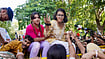 Photo: Rushikesh More | PTI : All India Students' Association (AISA) national president Neha Bora climbs a police barricade near Ashoka Road during a protest demanding the removal of Chief Election Commissioner (CEC) Gyanesh Kumar, in New Delhi.