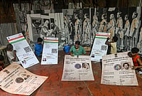 Day In Pics: October 04, 2026 | Photo: PTI : Artists and club members finish installation of giant replicas of Aadhar and voter identity cards of legendary poet Rabindranath Tagore, former president and scientist APJ Abdul Kalam and Mother Teresa, amid preparations for the 'Durga Puja' festival, at 'Humanity' themed Khidirpur Jubak Sangha community pandal, in Kolkata, West Bengal.