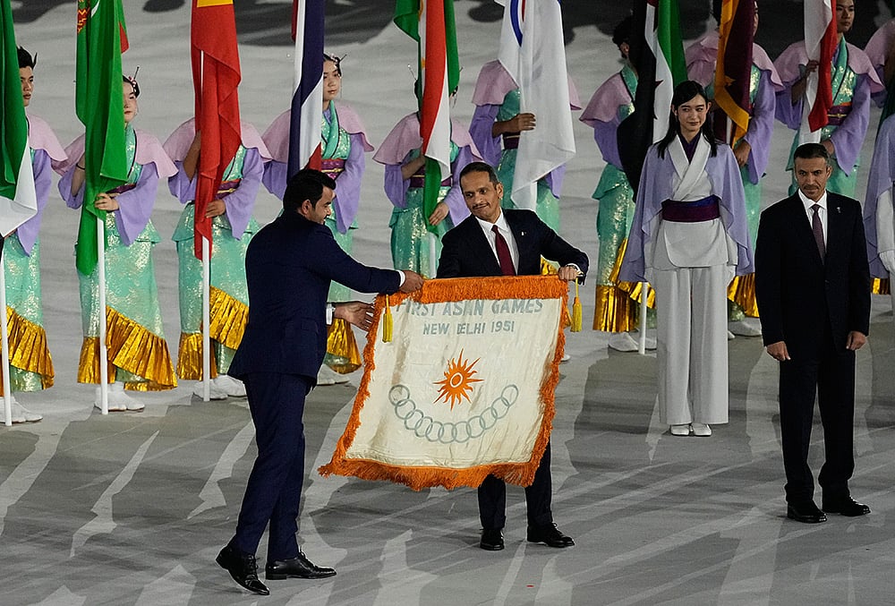 Prime Minister of Qatar, receives the flag of the first Asian Games