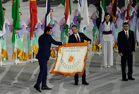 Sheikh Mohammed bin Abdulrahman Al Thani, Prime Minister of Qatar, receives the flag of the first Asian Games during the closing ceremony for the Asian Games in Nagoya, Japan, Sunday, Oct. 4, 2026. 
