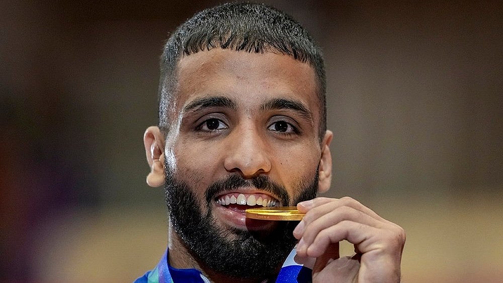 India's Sujeet Kalkal poses for photographs after winning gold medal in the men's Freestyle 65 kilogram final bout 196 wrestling event in the ongoing Asian Games 2026, in Nagoya, Japan, Friday, Oct. 2, 2026. 
 - | Photo: PTI/Arun Sharma