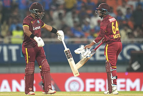 West Indies' Shai Hope, left, and Gudakesh Motie interact between the wickets during the third and final One Day International (ODI) cricket match of a series between India and West Indies, in Mullanpur, Saturday, Oct. 3, 2026. 