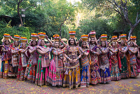 Artists wearing traditional attire pose for photograph before practice the Garba, a traditional dance of Gujarat state, during a rehearsal of Navratri, or the nine night Hindu festival, in Ahmedabad, India, Sunday, Oct. 4, 2026.  
