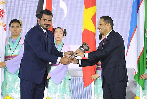 President of the Olympic Council of Asia, Sheikh Joaan Bin Hamad Al Thani, left, hands the games torch to Sheikh Mohammed bin Abdulrahman Al Thani, Prime Minister of Qatar during the closing ceremony for the Asian Games in Nagoya, Japan, Sunday, Oct. 4, 2026.