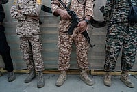 | Photo: AP/Vahid Salemi : Men affiliated with the Revolutionary Guard stand during the opening ceremony of one of the military training centers for volunteers being set up throughout squares in downtown Tehran, Iran, Saturday, Oct. 3, 2026. 
