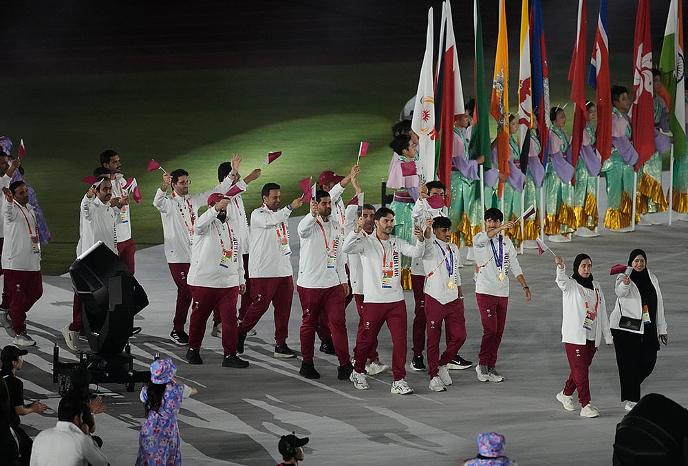 Qatar athletes look on during the closing ceremony