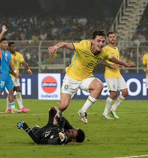 India's Prabsukhan Gill, black, and Brazil's Breno Bidon vie for the ball during an International friendly Football match between India and Brazil, in Kolkata, Saturday, Oct. 3, 2026. 
