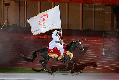Qatar equestrian athlete Jassim Al Kuwari rides with the Olympic Council of Asia flag during the closing ceremony for the Asian Games in Nagoya, Japan, Sunday, Oct. 4, 2026. 