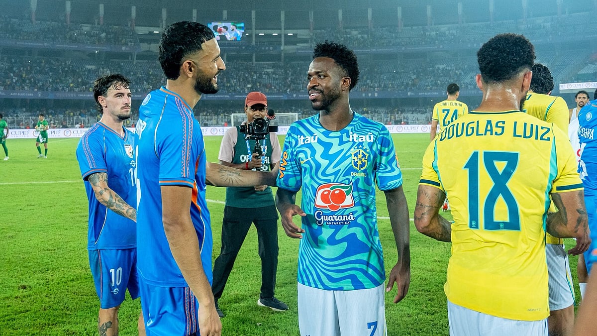 Indian footballers catch up with Brazil footballers after the match at the Salt Lake Stadium in Kolkata.  - IndianFootball/X