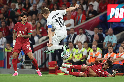 Portugal's Joao Felix tries to tackle Norway's Martin Odegaard during the Nations League soccer match between Portugal and Norway in Porto, Portugal, Sunday, Oct. 4, 2026.