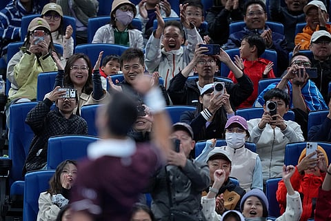 Spectators cheer after Novak Djokovic, of Serbia, winning the second set against Alexander Zverev, of Germany, during the men's singles quarterfinals match at the China Open tennis tournament in Beijing, Sunday, Oct. 4, 2026.
