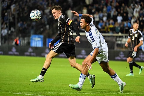 Germany's Florian Wirtz, left, challenges for the ball with Greece's Charalampos Kostoulas during the UEFA Nations League soccer match between Greece and Germany in Thessaloniki, northern Greece, Sunday, Oct. 4, 2026.