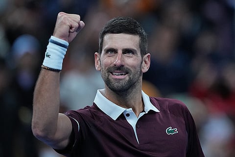 Novak Djokovic, of Serbia, celebrates after defeating Alexander Zverev, of Germany, in the men's singles quarterfinals match at the China Open tennis tournament in Beijing, Sunday, Oct. 4, 2026.