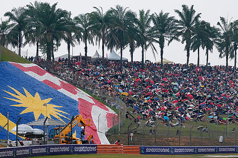 Spectators gather on a hillside ahead of the Bahrain Grand Prix in Sepang, Malaysia, Sunday, Oct. 4, 2026.
