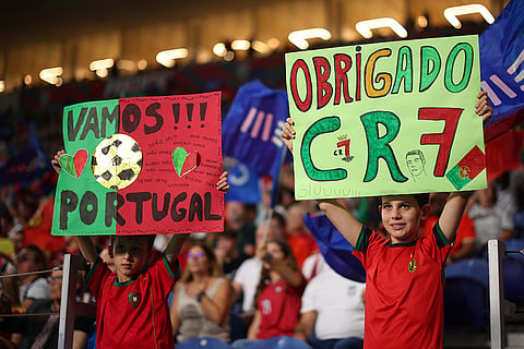 Portugal young fans hold up posters on the stands before the Nations League soccer match between Portugal and Norway in Porto, Portugal, Sunday, Oct. 4, 2026.