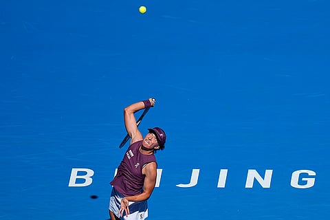 Iga Swiatek, of Poland, serve to Donna Vekic, of Croatia, during the third round of the women's singles match at the China Open tennis tournament in Beijing, Monday, Oct. 5, 2026.