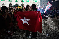 In Photos: Celebrations In Both Camps As Lula And Bolsonaro Heads To Run-Off | Photo: AP/Silvia Izquierdo : Supporters of President Luiz Inacio Lula da Silva, who is running for reelection, kiss as they react to partial presidential election results in Rio de Janeiro, Sunday, Oct. 4, 2026.
