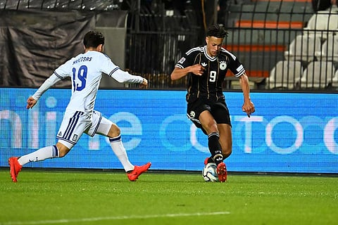 Germany's Derry Scherhant, right, and Greece's Konstantinos Karetsas challenge for the ball during the UEFA Nations League soccer match between Greece and Germany in Thessaloniki, northern Greece, Sunday, Oct. 4, 2026.