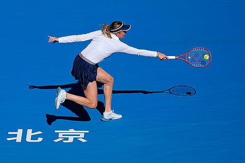 Iga Swiatek, of Poland, returns a ball to Donna Vekic, of Croatia, during the third round of the women's singles match at the China Open tennis tournament in Beijing, Monday, Oct. 5, 2026.