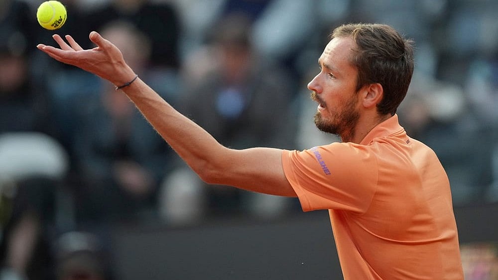 Daniil Medvedev of Russia serves a ball to Italy's Jannik Sinner during their semifinal match at the Italian Open tennis tournament in Rome. - | Photo: AP/Andrew Medichini