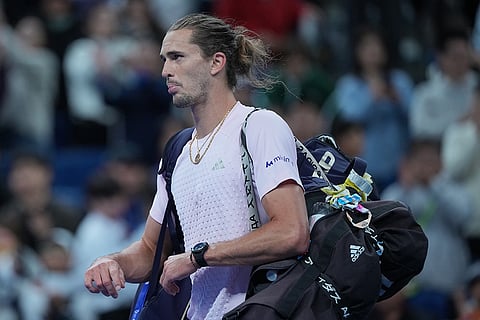 Alexander Zverev, of Germany, leaves after losing to Novak Djokovic, of Serbia, in the men's singles quarterfinals match of the China Open tennis tournament in Beijing, Sunday, Oct. 4, 2026. 