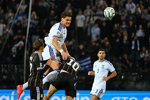 Greece's Konstantinos Mavropanos, top, heads the ball during the UEFA Nations League soccer match between Greece and Germany in Thessaloniki, northern Greece, Sunday, Oct. 4, 2026.