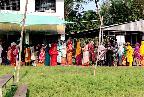 Women voters line up in a queue outside a polling station to cast their votes during the Assembly by-election in Nandigram constituency, Purba Medinipur district, West Bengal.