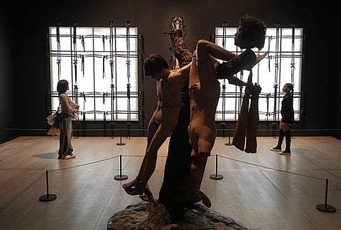 An artwork "Wandering about in the future, looking forward to the past," back, by Cathy de Monchaux, is displayed during a media preview of "The 90s: Art and Fashion exhibition" at Tate Britain in London, Tuesday, Oct. 6, 2026. 
