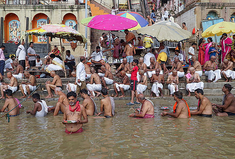 People perform 'Pind Daan' and 'Tarpan' rituals to pay homage to their ancestors on the banks of the Ganga river at Dashashwamedh Ghat during the ongoing Pitru Paksha period, in Varanasi.