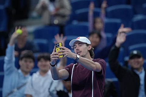 Alex De Minaur, of Australia, takes a selfie with fans as he celebrates after winning the men's single semi-final match against Hurkacz of Poland, at the China Open tennis tournament in Beijing, Monday, Oct. 5, 2026.