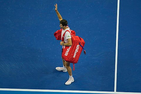 Hubert Hurkacz of Poland, waves as he leaves the court after he retired from the men's singles semi-final match at the China Open tennis tournament in Beijing, Monday, Oct. 5, 2026.
