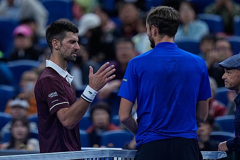 Daniil Medvedev, of Russia, right, talks to Novak Djokovic, of Serbia after being disqualified during a semi final match at the China Open tennis tournament in Beijing, Monday, Oct. 5, 2026.